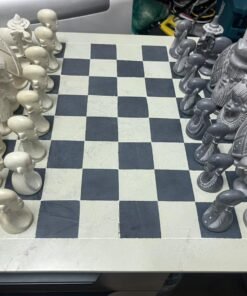 A hand-carved chess set made of soapstone, featuring a unique African artistic design.