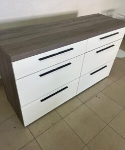 A modern white chest of drawers with a gray wood top from Home Centre