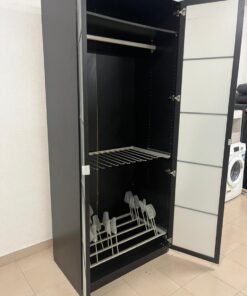 An IKEA PAX wardrobe featuring a black frame and frosted glass doors.