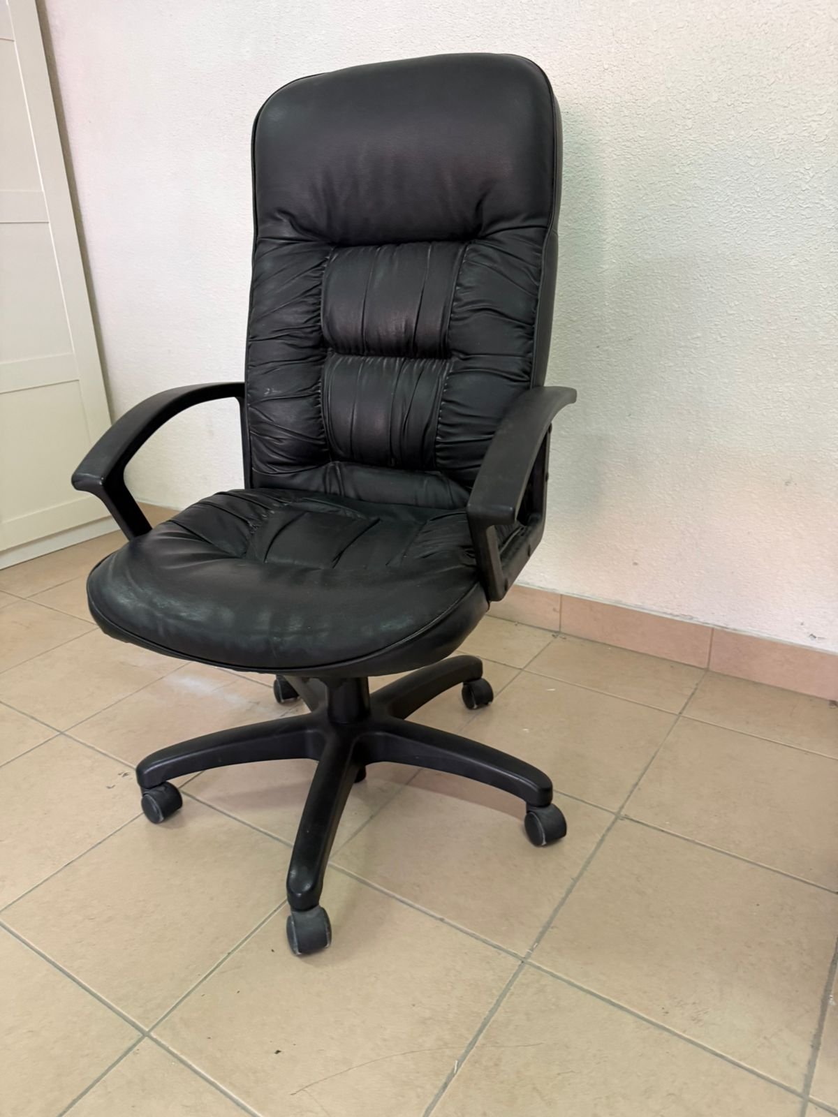 Executive office chair with high back and black faux leather upholstery