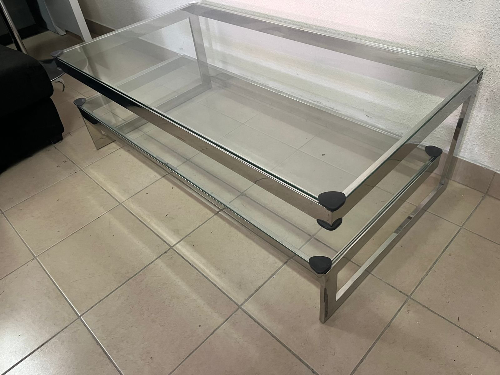 A chrome-plated coffee table with two thick glass shelves. French made.