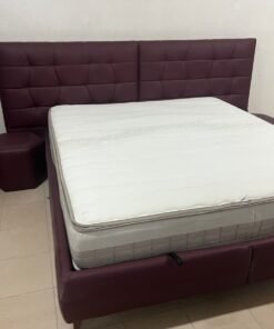 A modern hydraulic bed with an upholstered design and offers ample internal storage space.