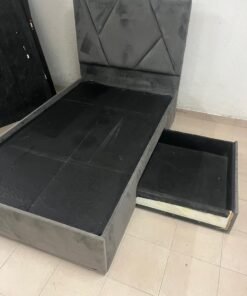 Gray upholstered bed frame with a storage drawer underneath 120x200 cm