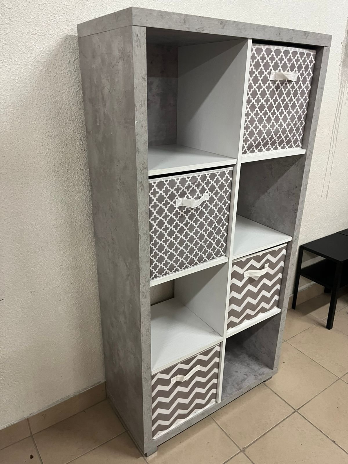 This gray wooden storage unit from Home Source features fold-down fabric drawers. - Image 2