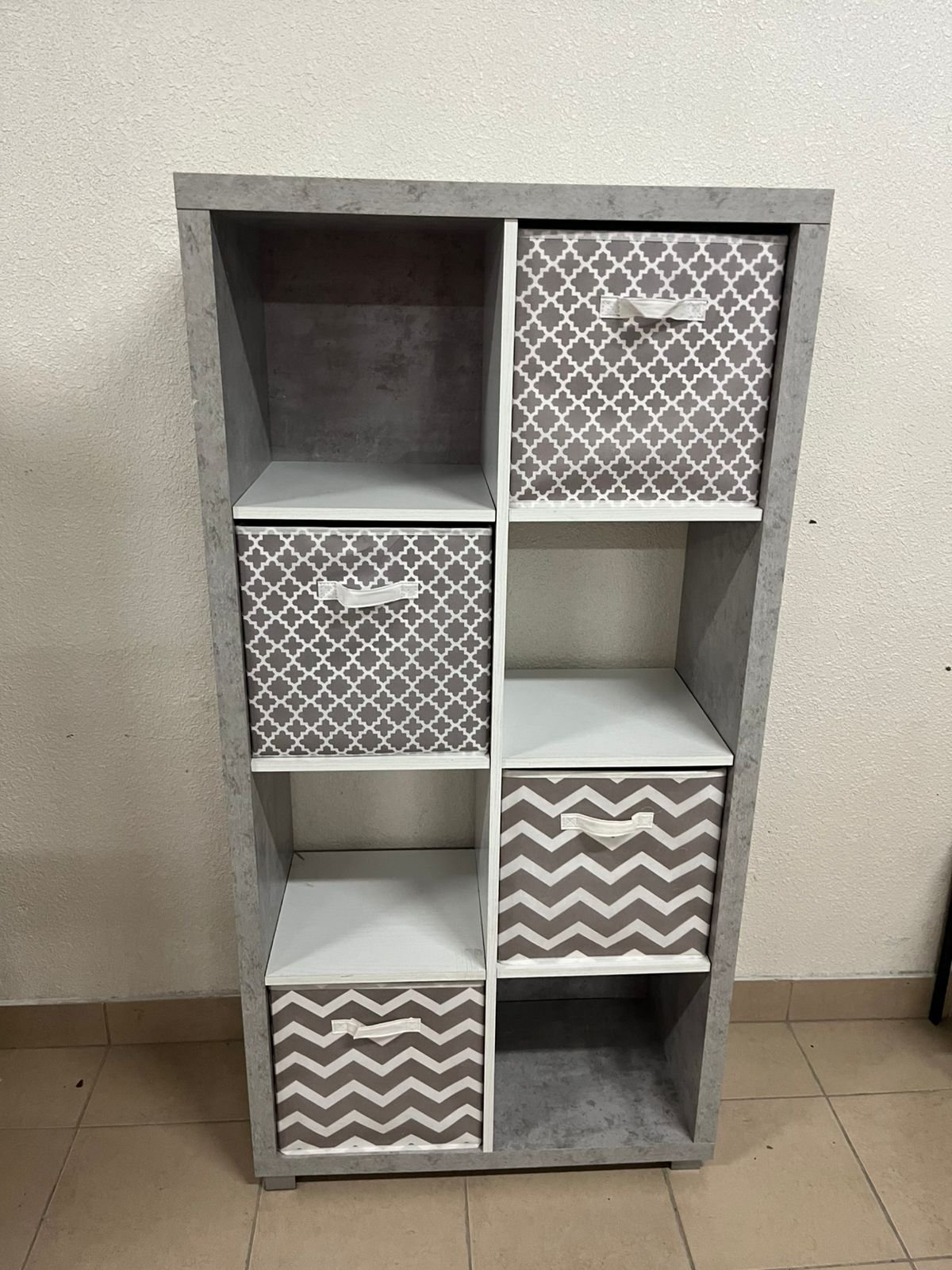 This gray wooden storage unit from Home Source features fold-down fabric drawers. - Image 3