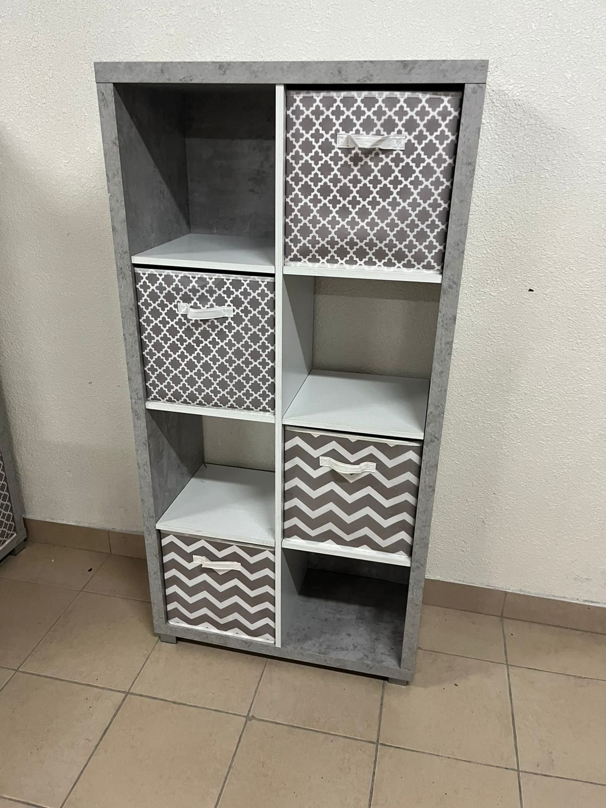 This gray wooden storage unit from Home Source features fold-down fabric drawers. - Image 4