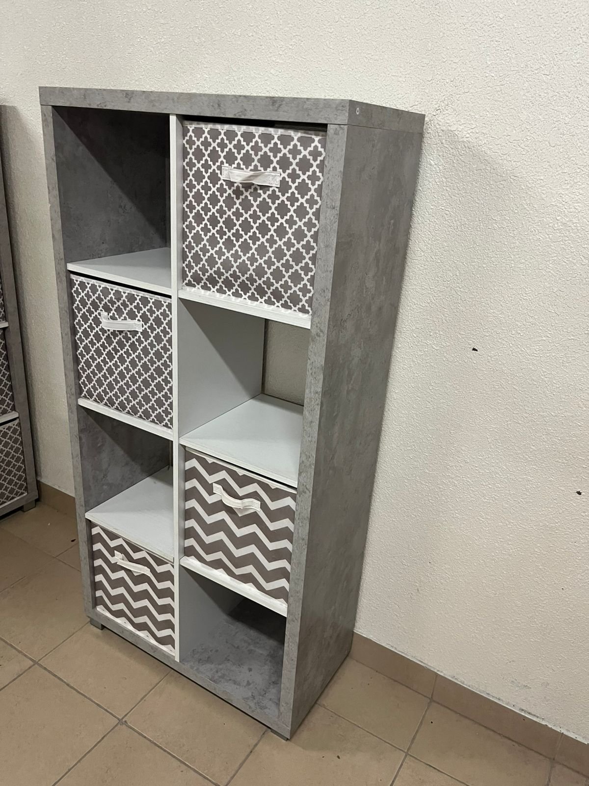 This gray wooden storage unit from Home Source features fold-down fabric drawers. - Image 7