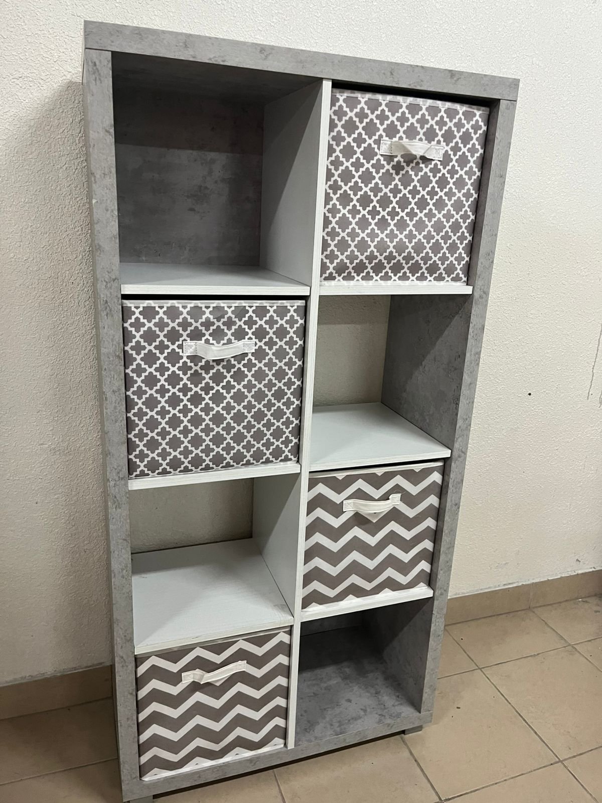 This gray wooden storage unit from Home Source features fold-down fabric drawers. - Image 8