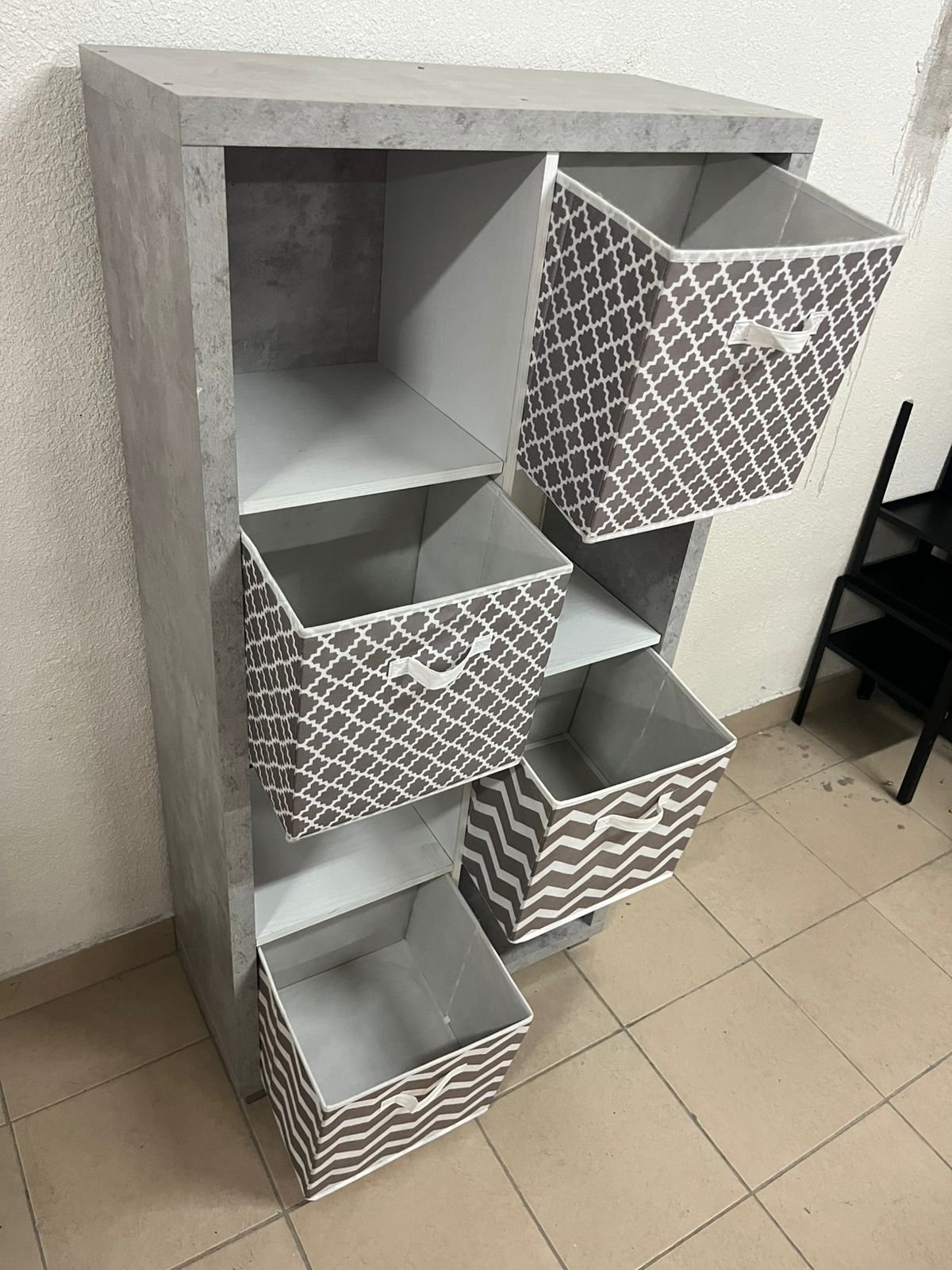 This gray wooden storage unit from Home Source features fold-down fabric drawers. - Image 9