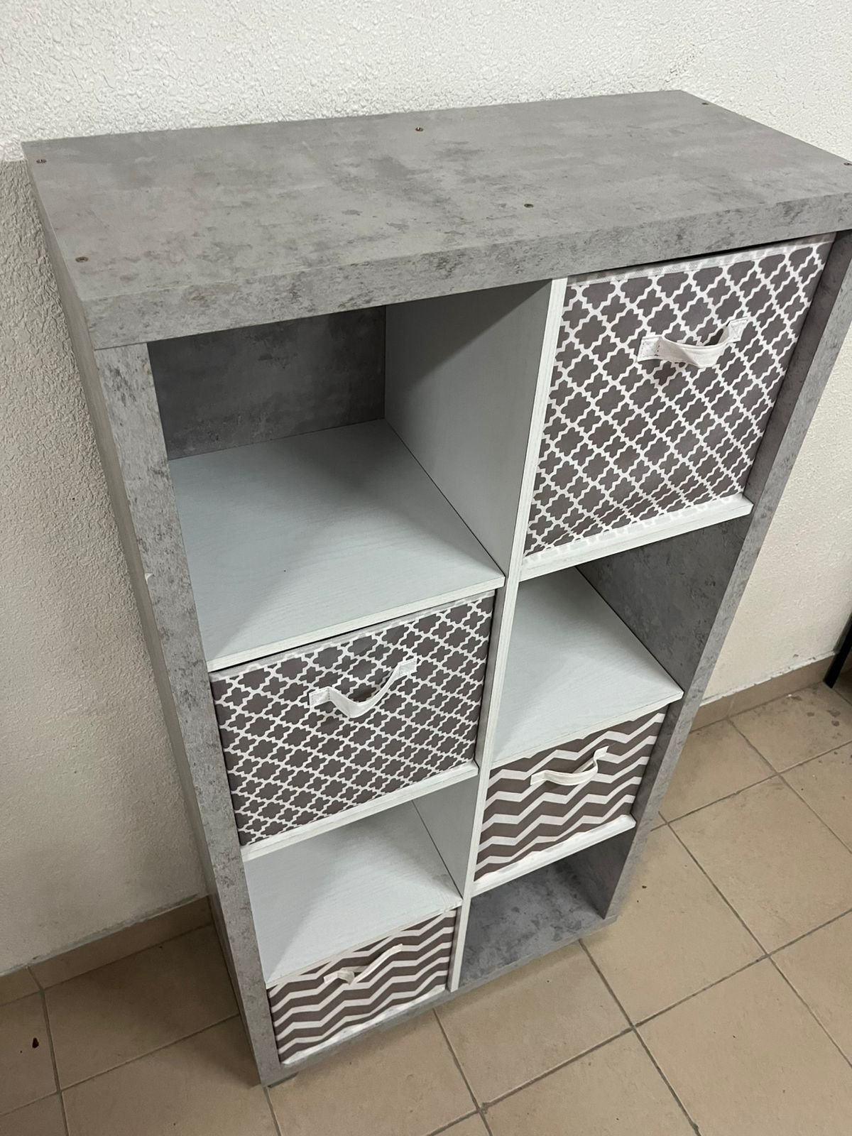 This gray wooden storage unit from Home Source features fold-down fabric drawers. - Image 12