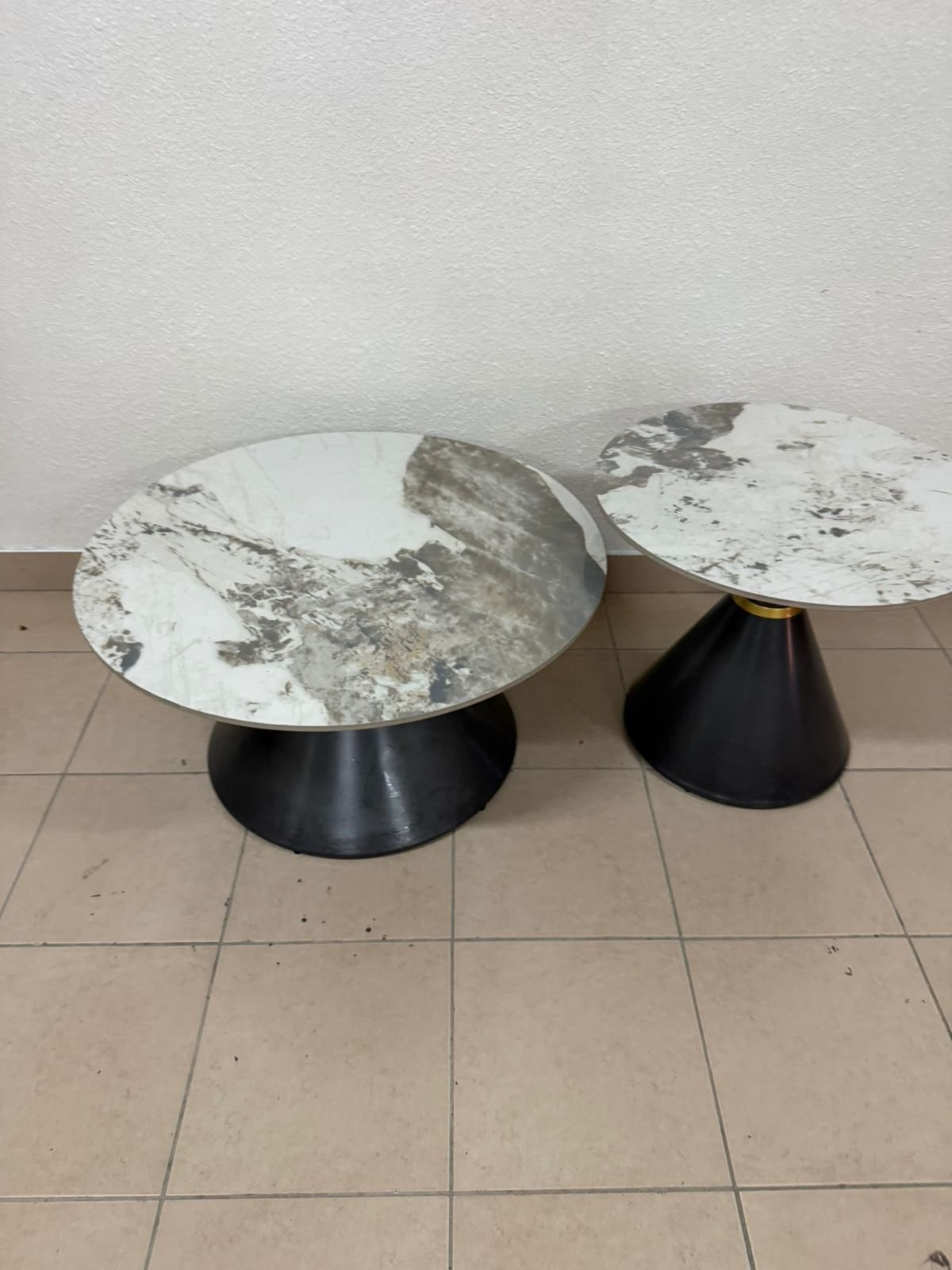 This is a round coffee table with a marble top and a black metal base in a modern design. - Image 3
