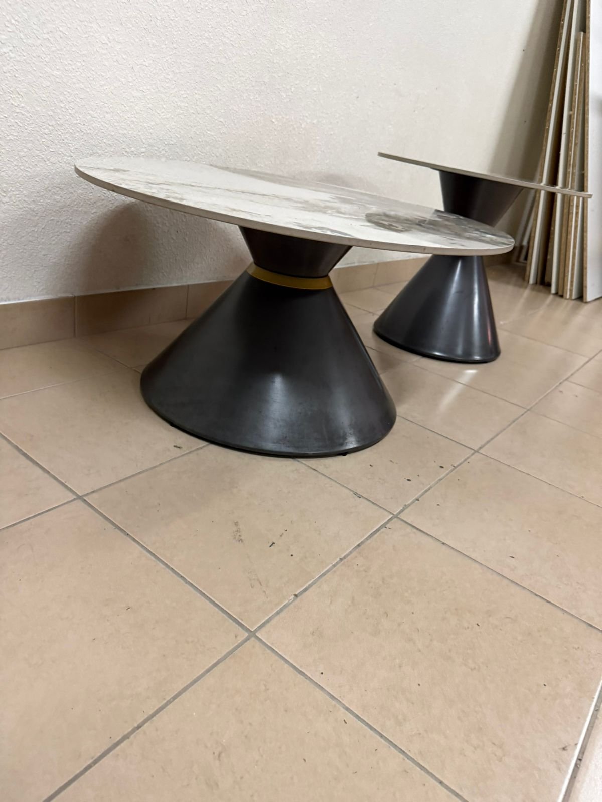 This is a round coffee table with a marble top and a black metal base in a modern design. - Image 10