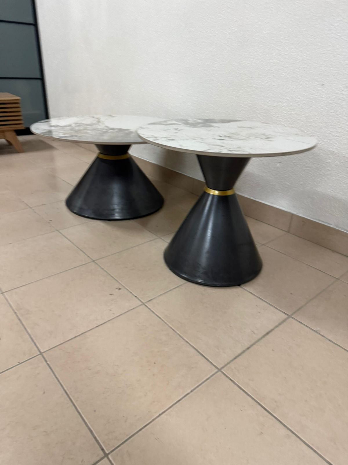 This is a round coffee table with a marble top and a black metal base in a modern design. - Image 11