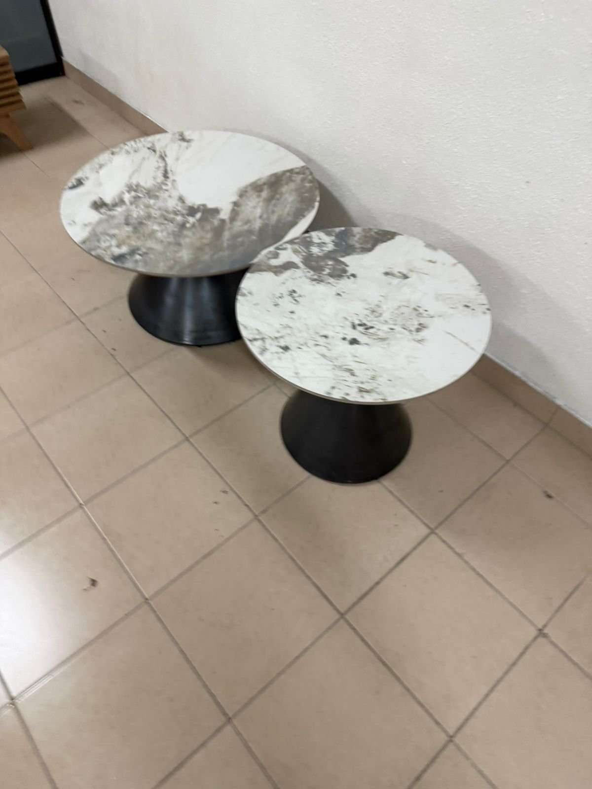 This is a round coffee table with a marble top and a black metal base in a modern design. - Image 13
