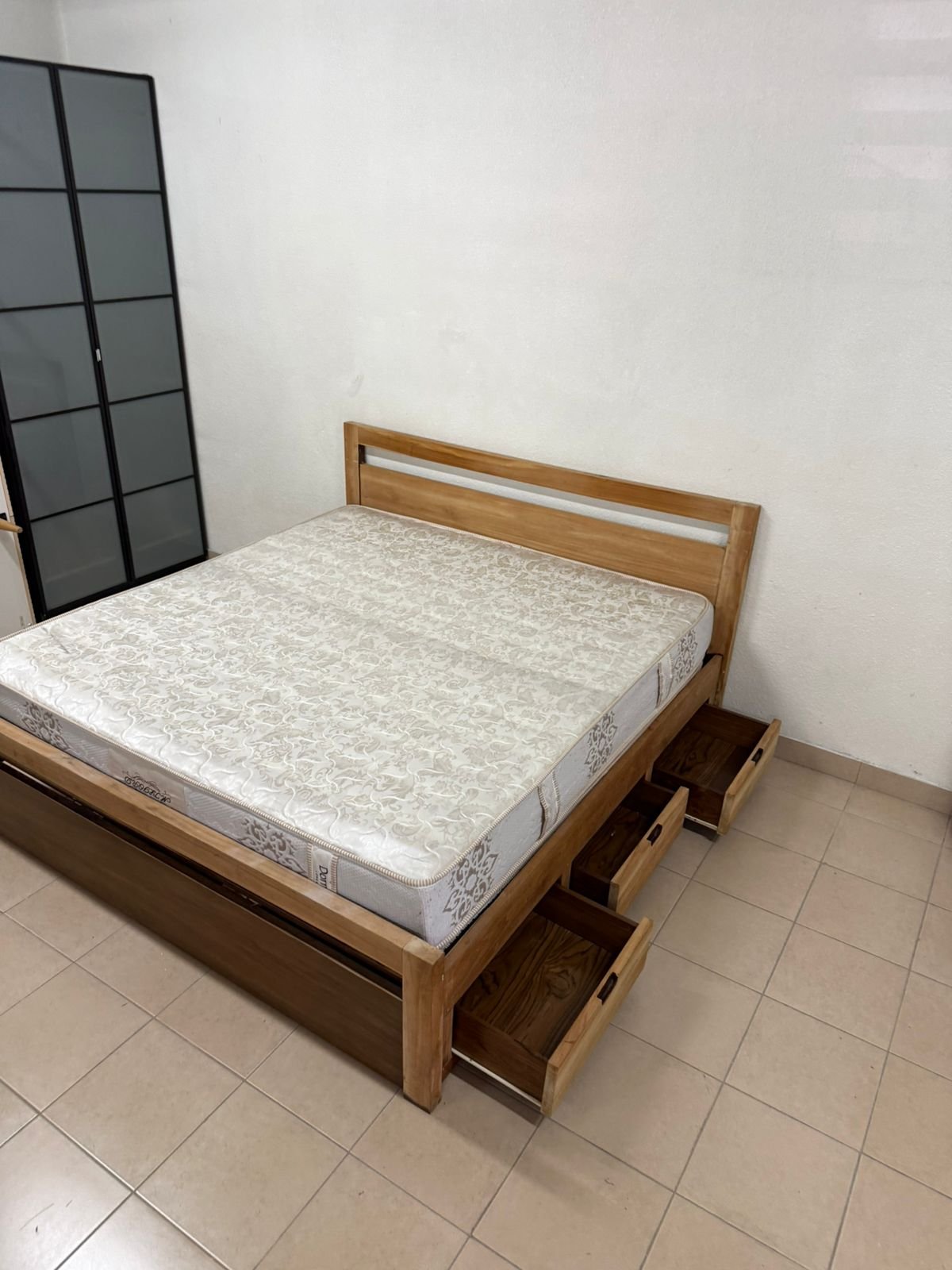 Natural wood bed with a modern design and built-in storage drawers