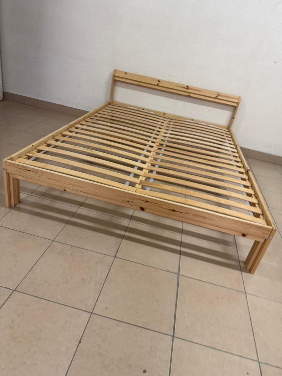This is an IKEA NEIDEN pine wood bed frame with LÖNSET slatted bed base.