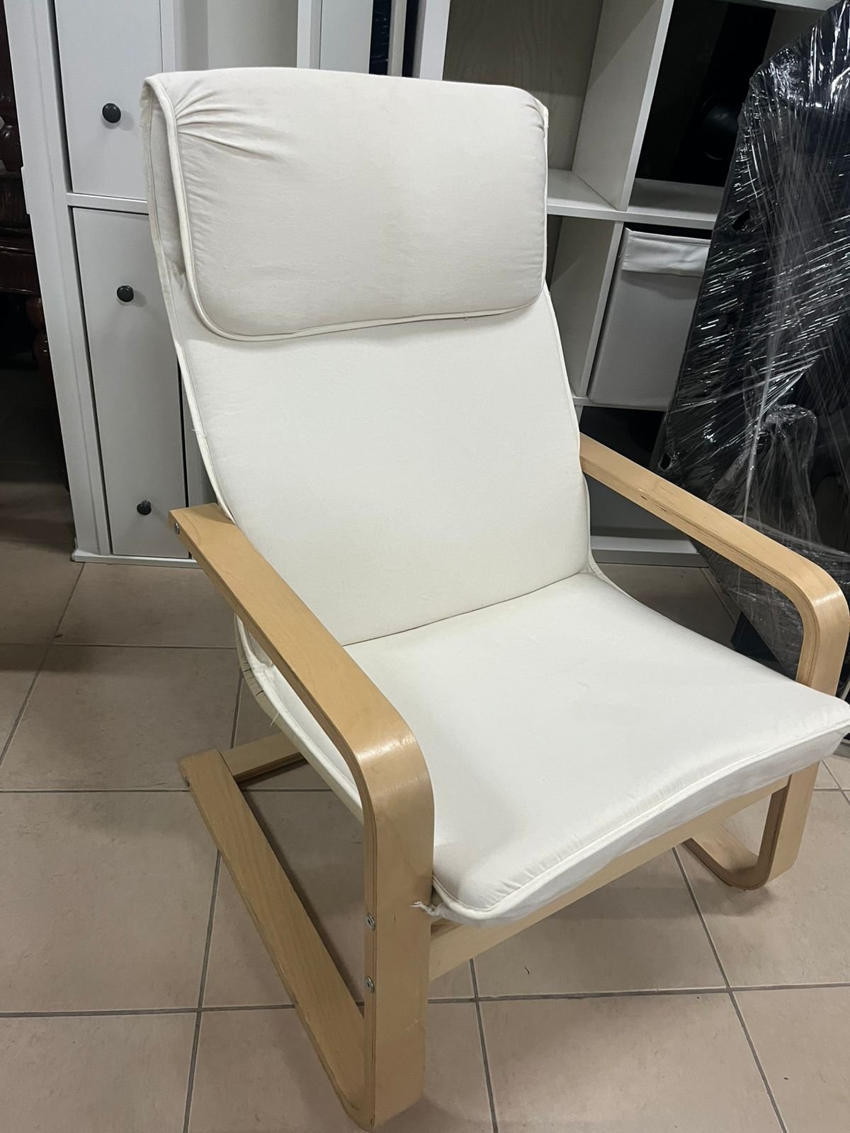 Chair - from IKEA with a natural wood frame and beige cushion