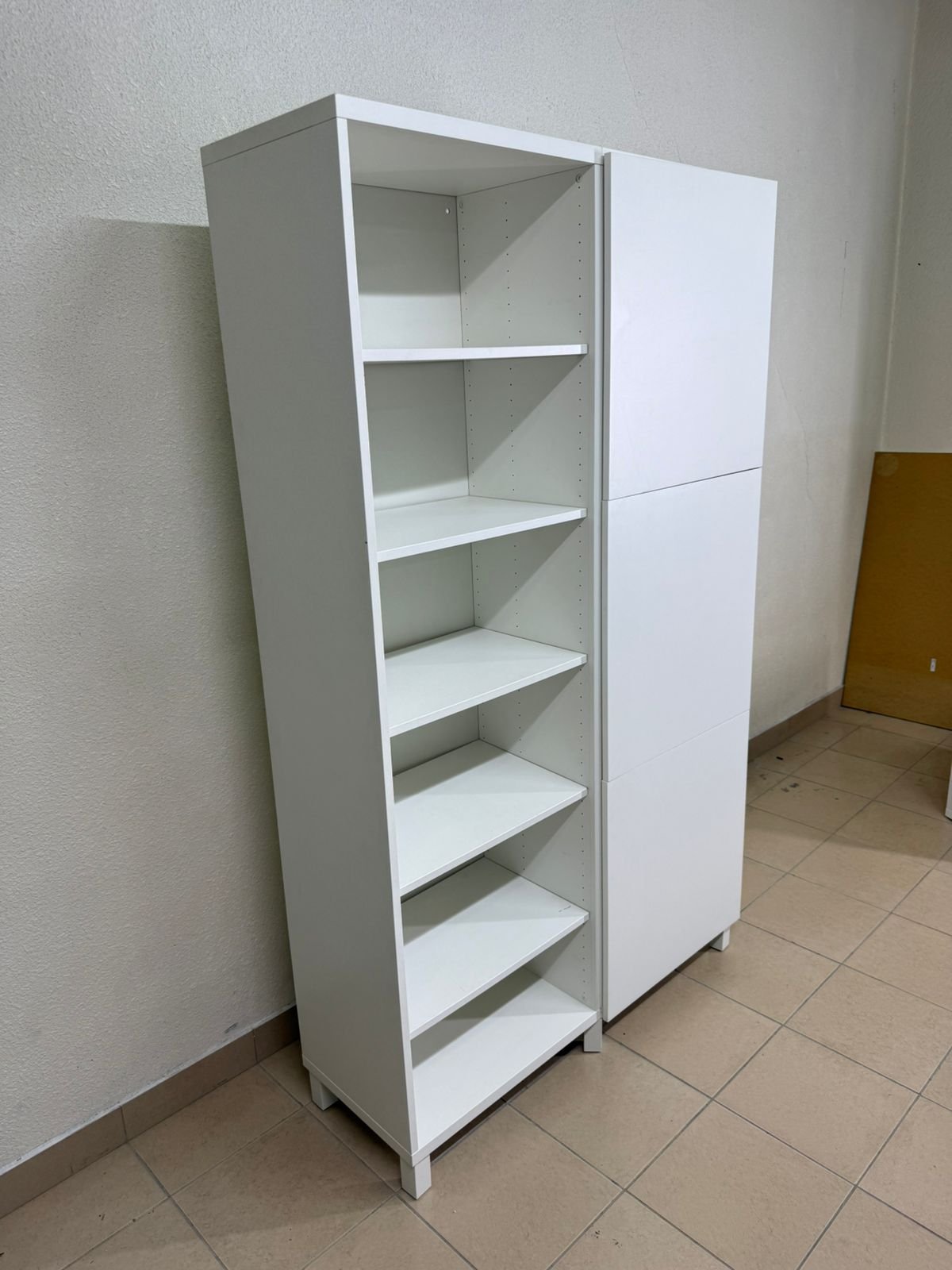 A white storage cabinet from IKEA, model BESTÅ, comes with open units and closed fronts. - Image 3