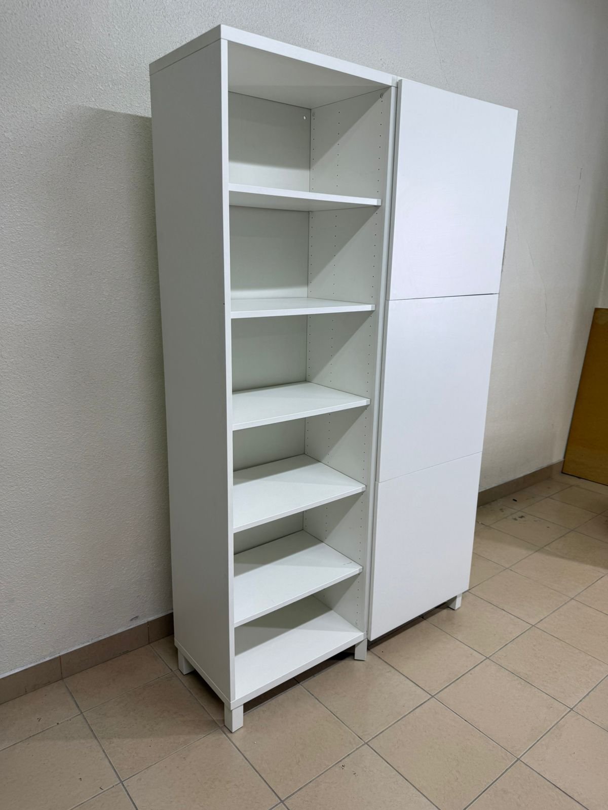 A white storage cabinet from IKEA, model BESTÅ, comes with open units and closed fronts. - Image 4