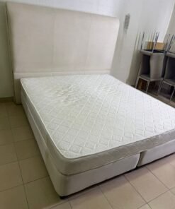 Beige upholstered double bed with mattress
