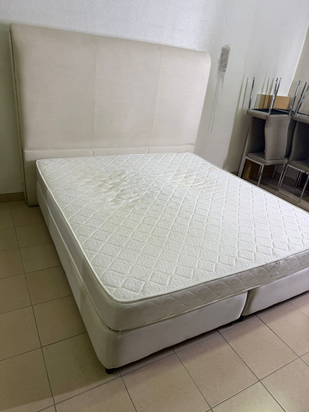 Beige upholstered double bed with mattress