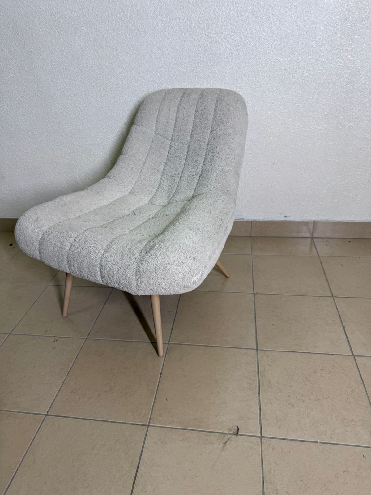 The chair is the Aubrey stool in cream, upholstered in Boucle fabric by Ashcroft.