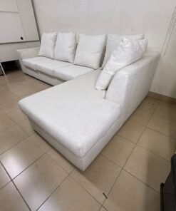 Light-colored sectional (L-shaped) sofa with comfortable back cushions