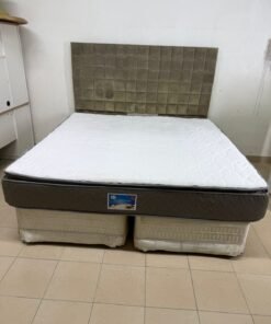 Double bed with a mattress, high headboard, and padded headboard
