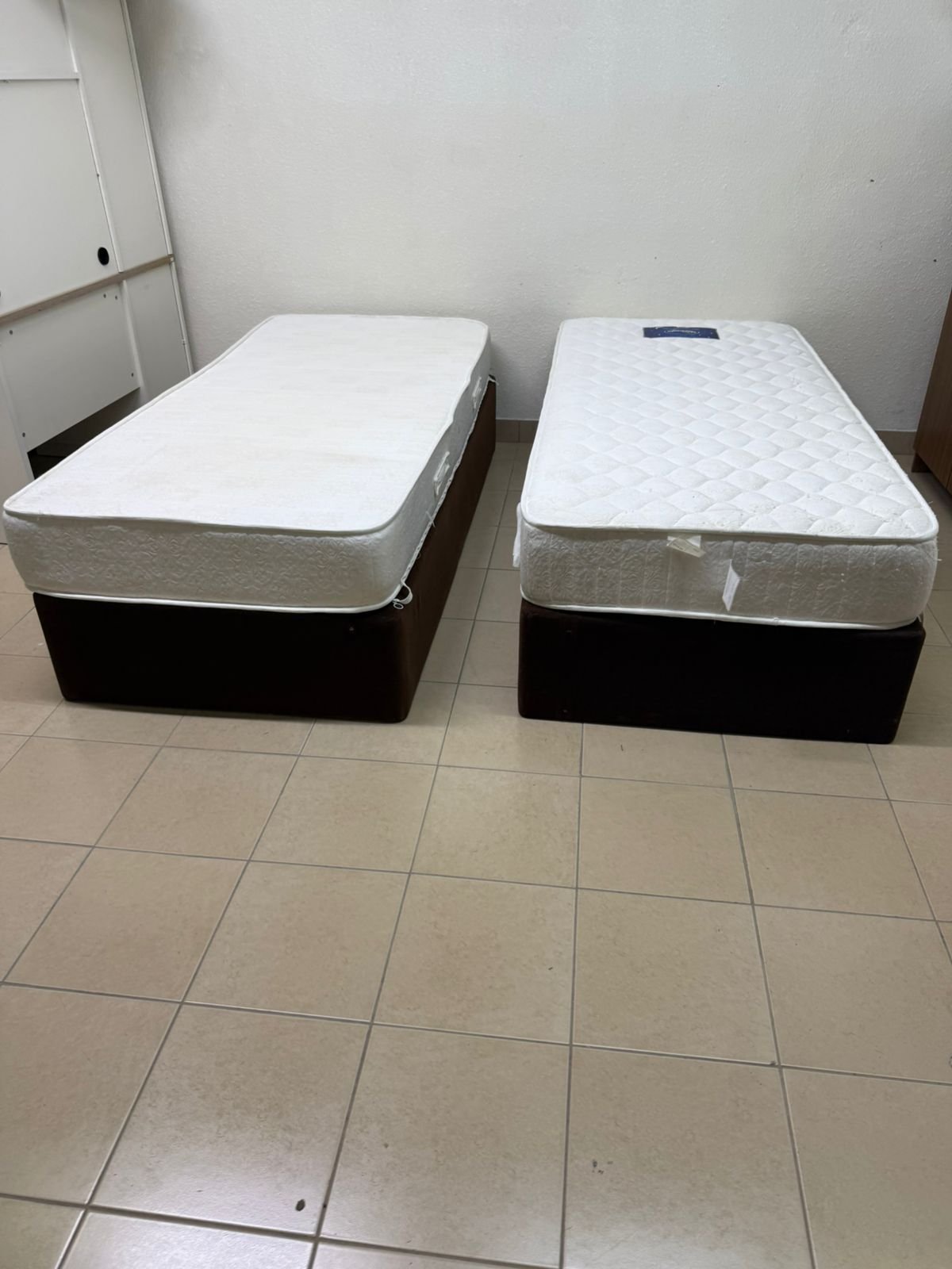Two single beds with mattresses