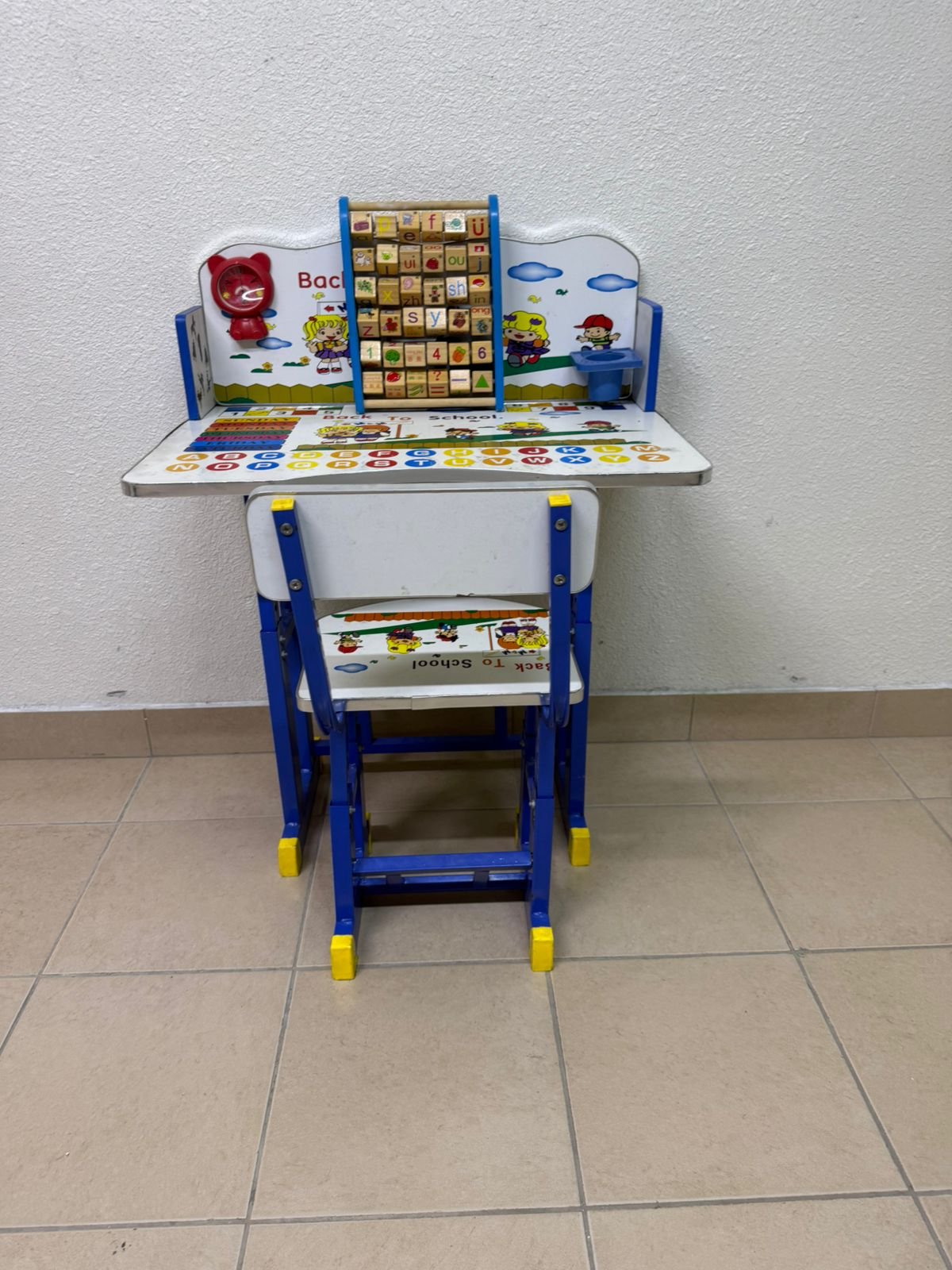 Adjustable children's study table and chair set including educational tools