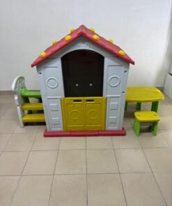 It is a playhouse designed for children, equipped with a table and two chairs.