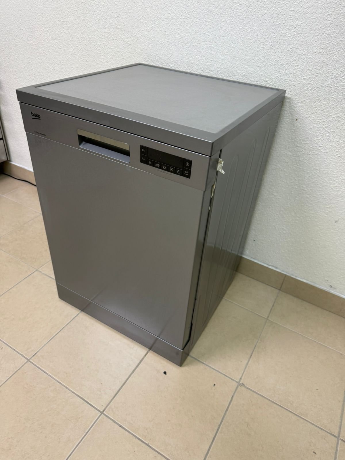A freestanding dishwasher from Beko, featuring a silver color and modern design.