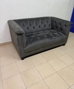 A grey velvet "Meridian Michelle" sofa featuring nail details and a comfortable design.