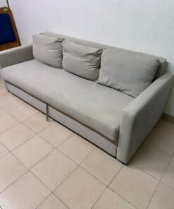This sofa bed is the FRIDHULT model from IKEA, featuring a light gray color and Knisa fabric.
