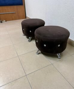 A pair of round brown pouf chairs from the Wimarspoon brand