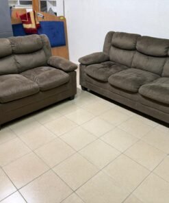 A comfortable brown sofa set with padded headrests, ideal for living rooms.