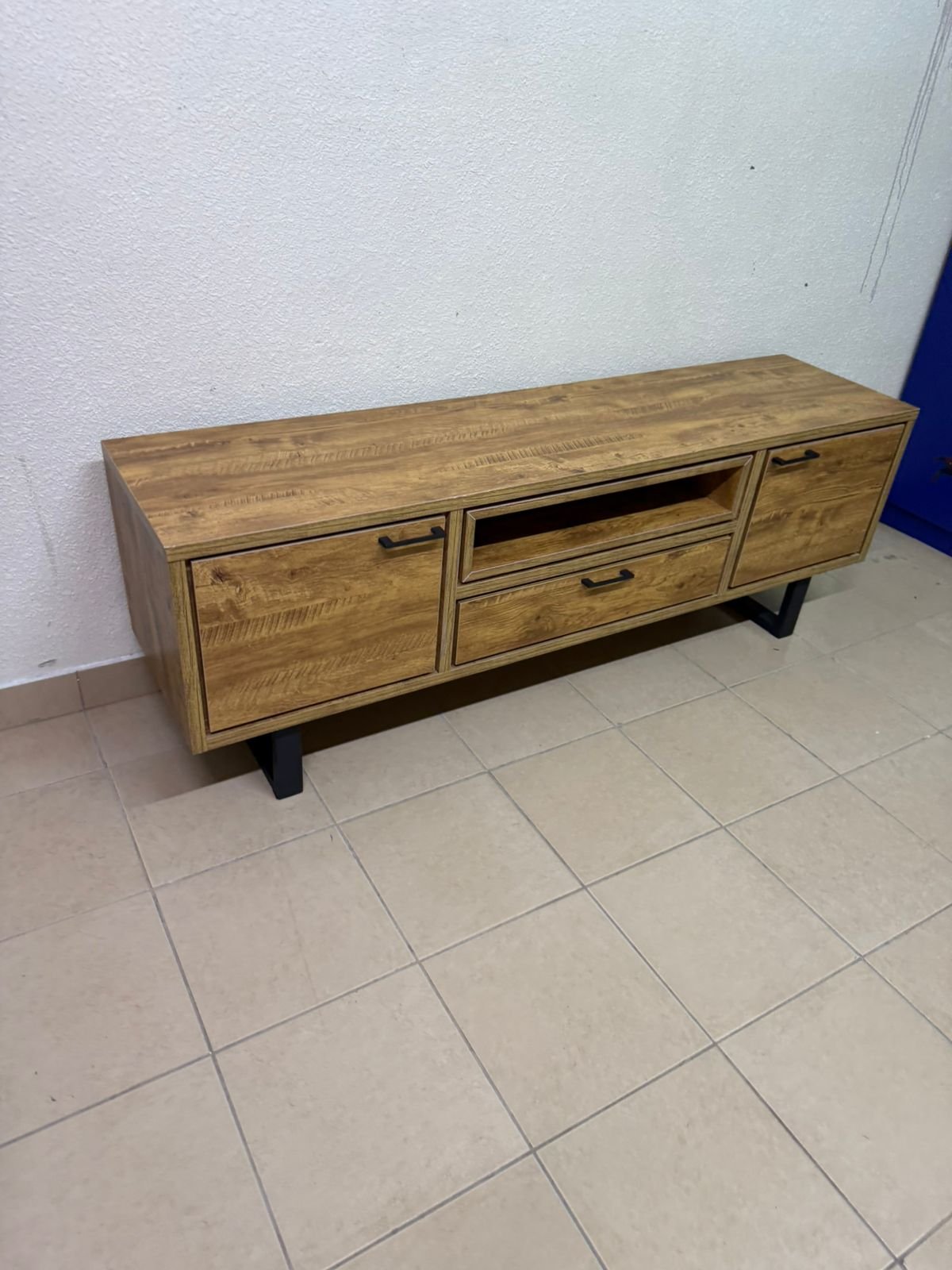 This modern TV unit features a warm beige wood finish and sturdy black metal legs. - Image 10