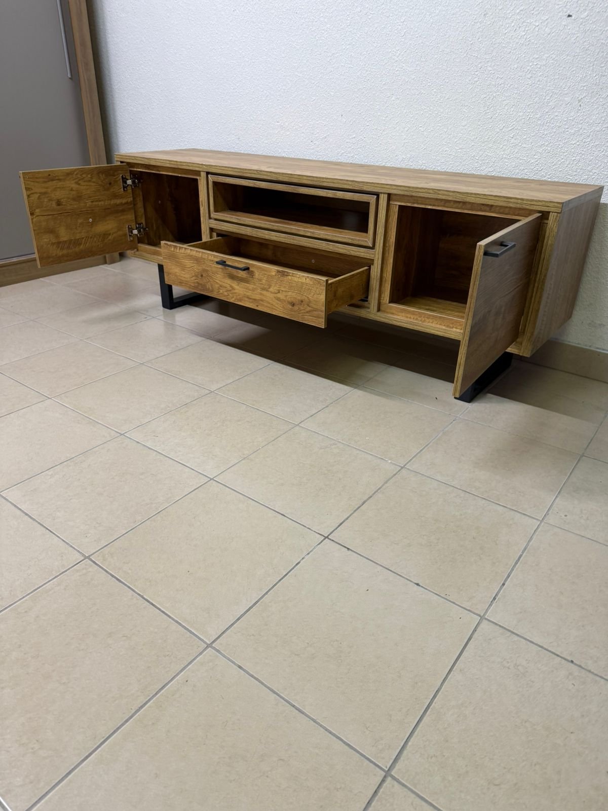 This modern TV unit features a warm beige wood finish and sturdy black metal legs. - Image 8