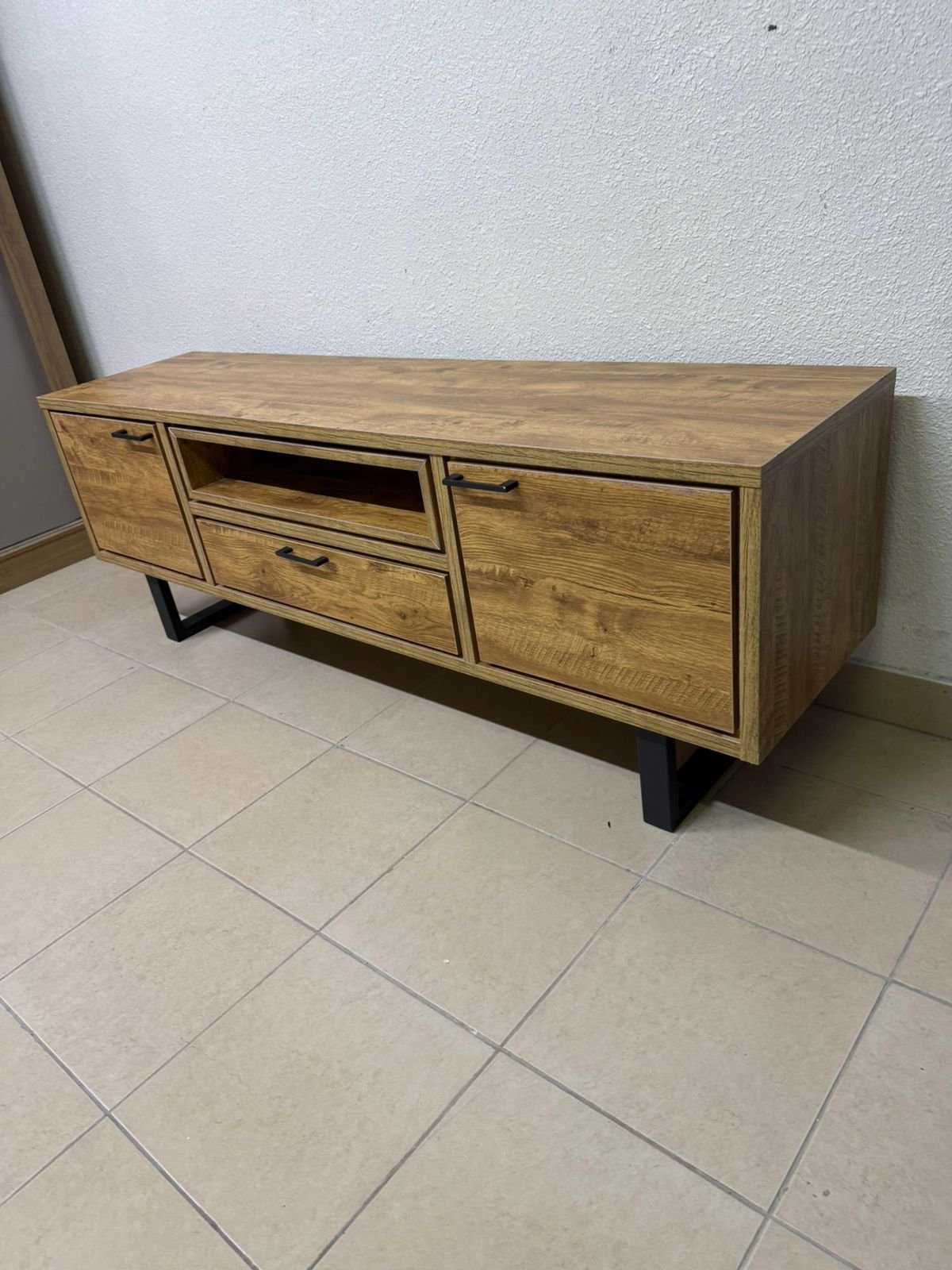 This modern TV unit features a warm beige wood finish and sturdy black metal legs. - Image 9