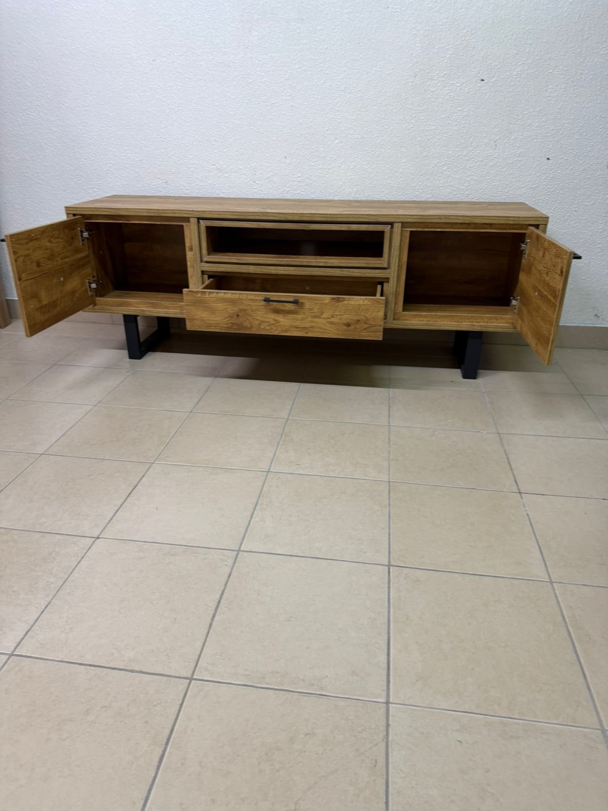 This modern TV unit features a warm beige wood finish and sturdy black metal legs. - Image 4