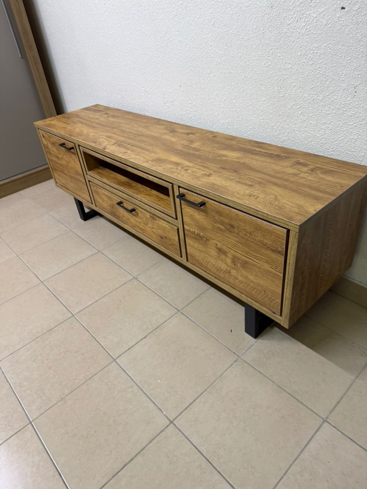 This modern TV unit features a warm beige wood finish and sturdy black metal legs. - Image 2