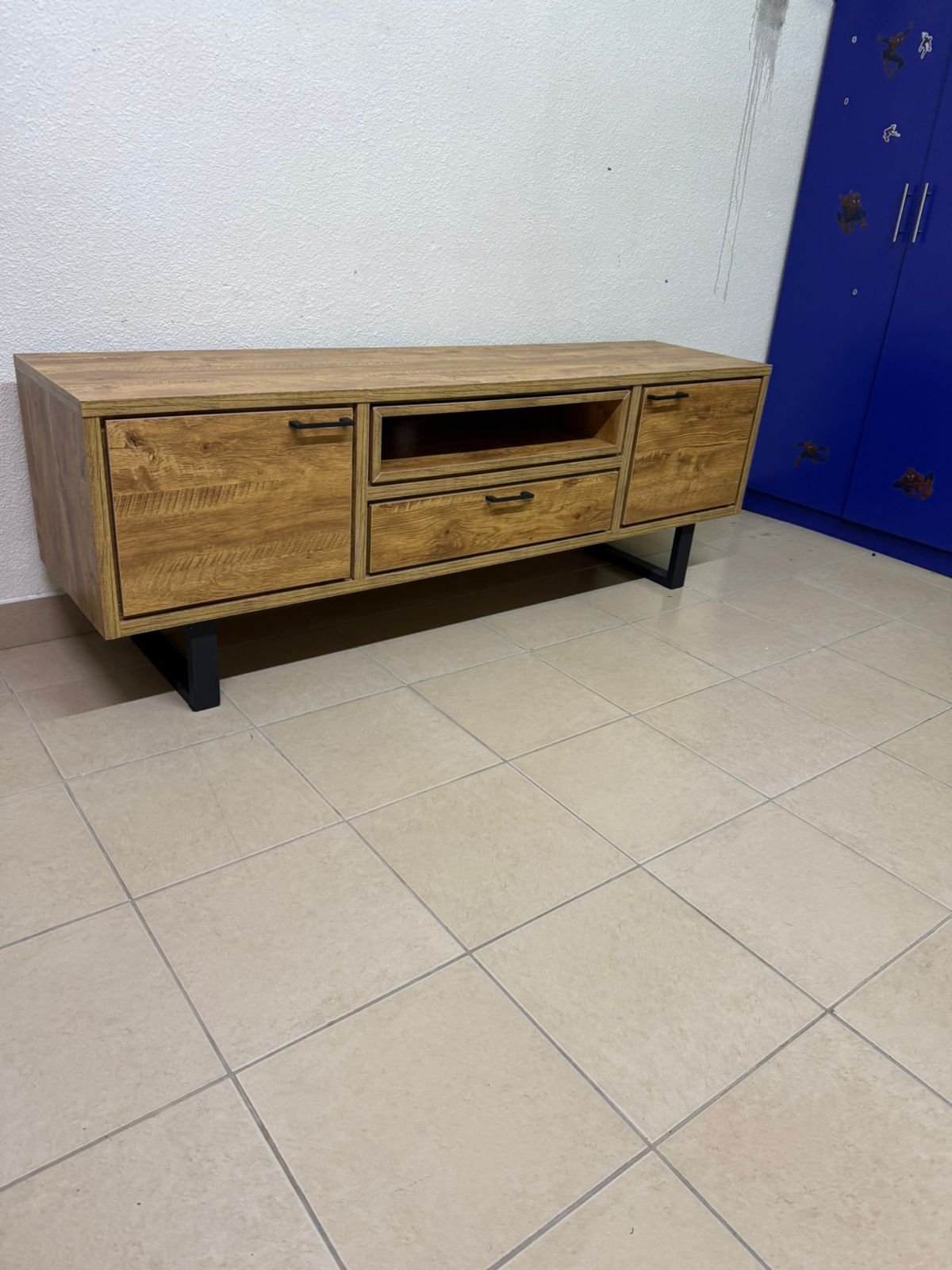 This modern TV unit features a warm beige wood finish and sturdy black metal legs. - Image 3