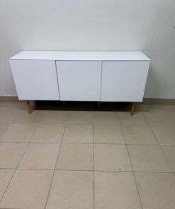 A modern white buffet cabinet featuring a simple design and light-colored wooden legs.