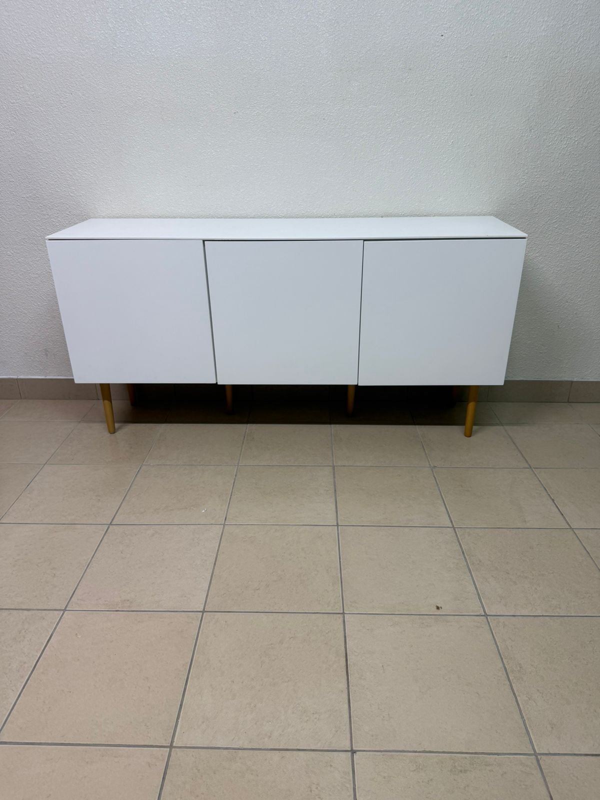A modern white buffet cabinet featuring a simple design and light-colored wooden legs. - Image 6