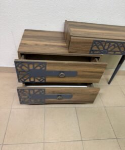 A modern dressing table with a wood-brown color and black geometric details.