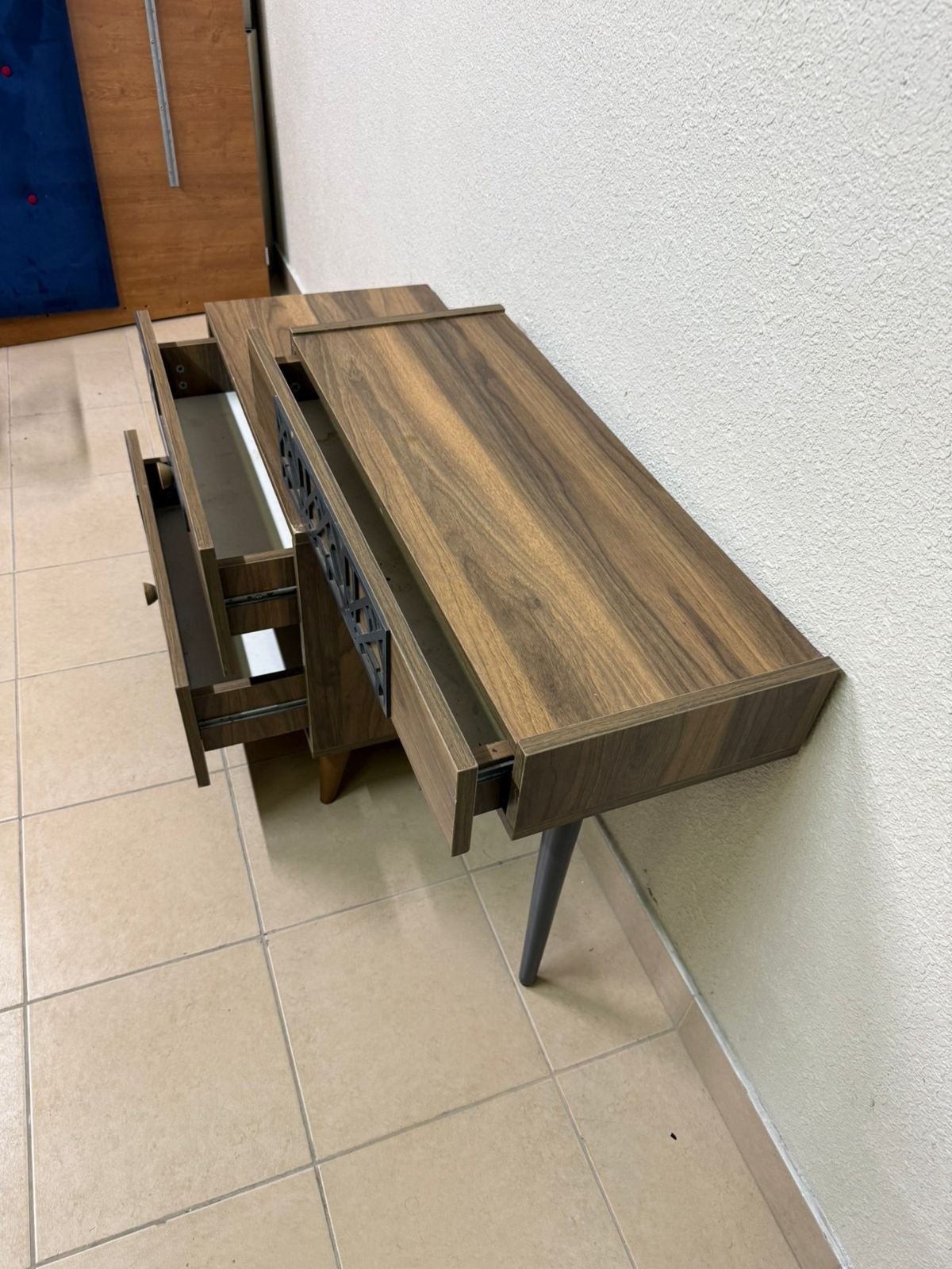 A modern dressing table with a wood-brown color and black geometric details. - Image 7