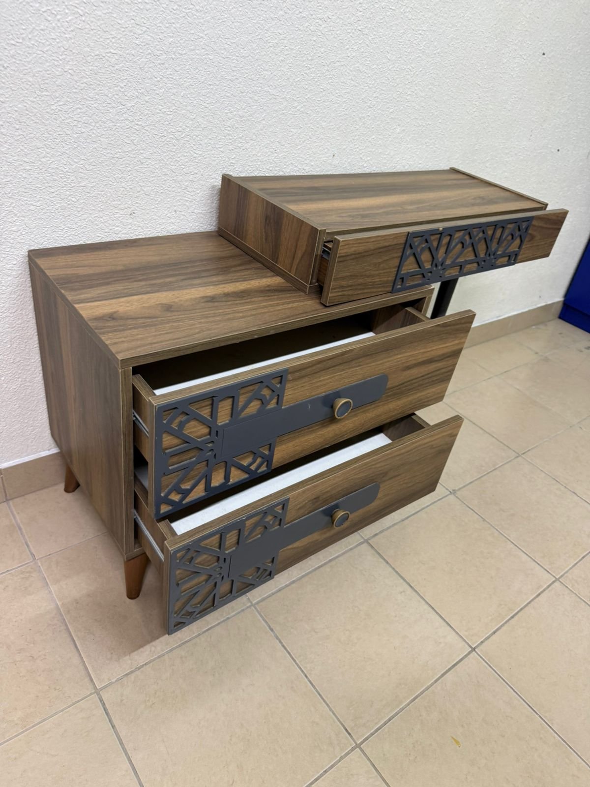 A modern dressing table with a wood-brown color and black geometric details. - Image 2