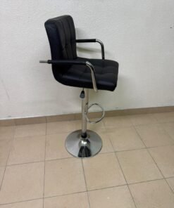 This black bar stool features a padded design and a chrome base.