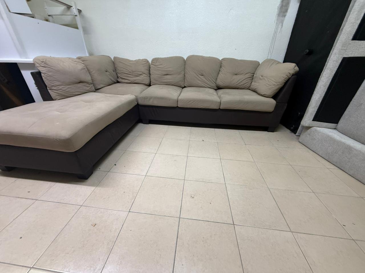 Beige and brown fabric sofa, intricate corner design