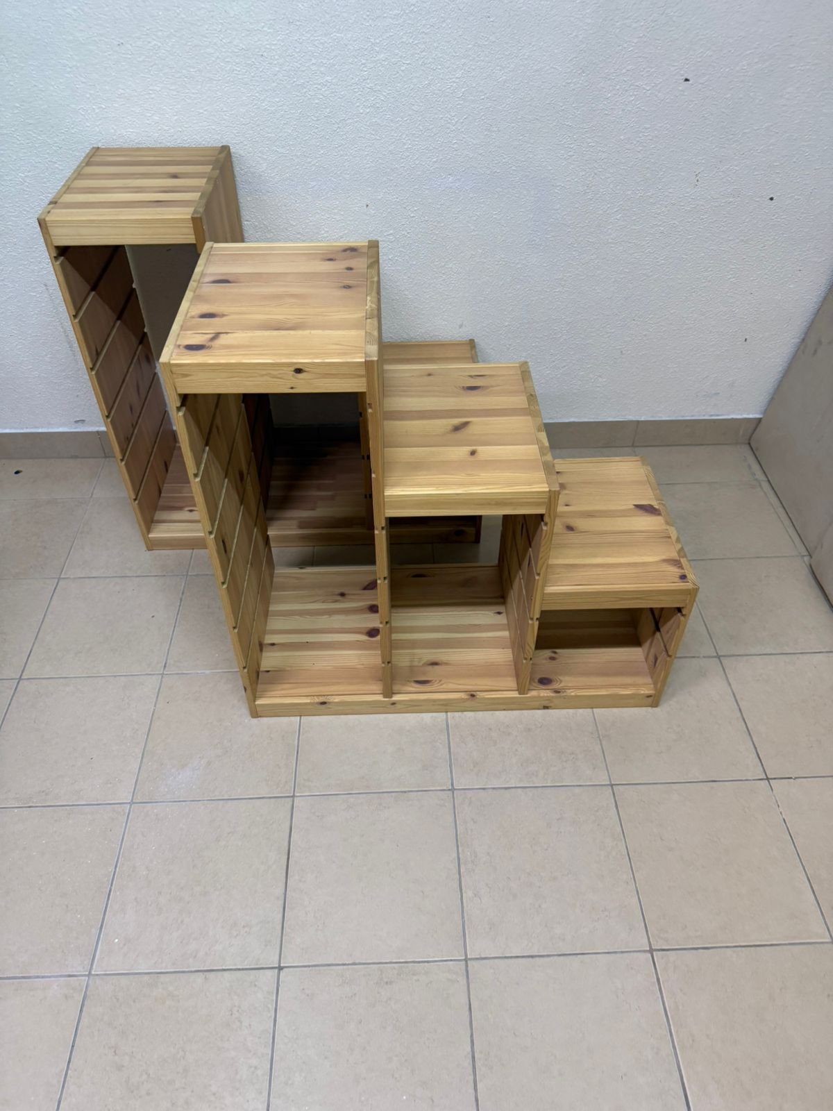 This wooden frame from IKEA is part of the TROFAST storage series and features a stepped design made of pine wood.